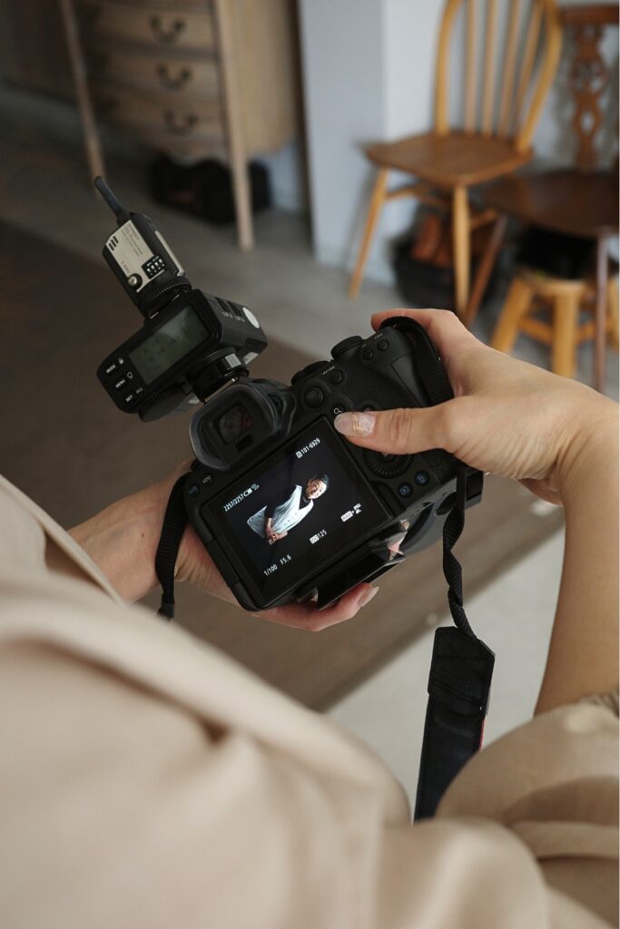 モナミ写真館で撮影した写真をカメラ画面で確認する兵藤ゆきえさん。人物撮影の現場風景。